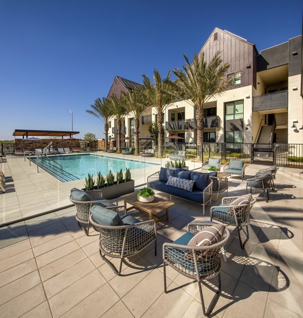 Resort-style pool at Silo Apartments, with lounge chairs and lush landscaping