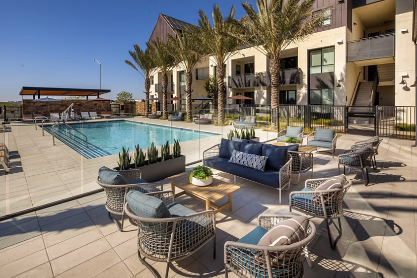 Silo Apartments: Modern pool area with lounge chairs and umbrellas