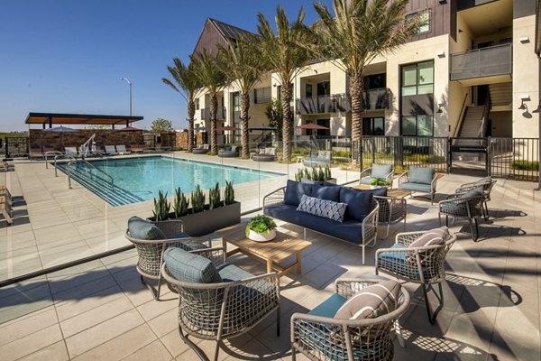 Silo Apartments: Modern pool area with lounge chairs and umbrellas