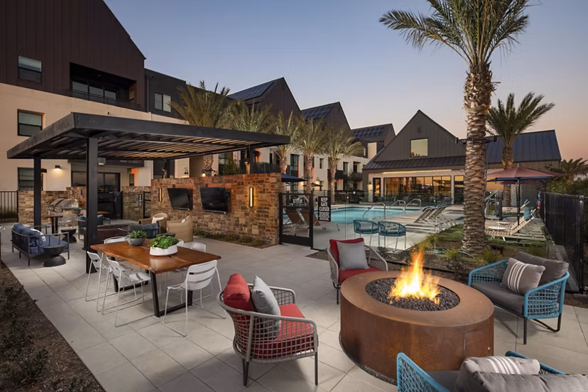 Fire pit lounge area with cozy seating at Silo Apartments: luxury amenity in a vibrant community