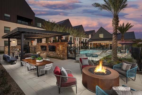 Fire pit lounge area with cozy seating at Silo Apartments offering luxury living by Greystar