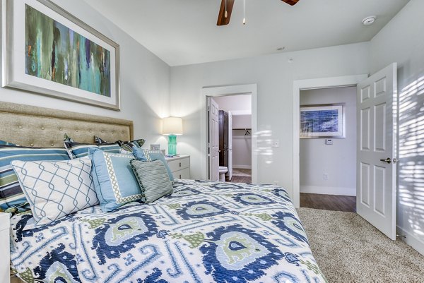 Bright bedroom with a cozy bed and modern decor at Ventura Ridge Apartments