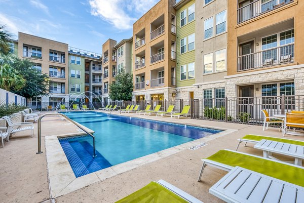 Resort-style pool at Ventura Ridge Apartments with lounge seating and landscaped surroundings, perfect for relaxation and socializing