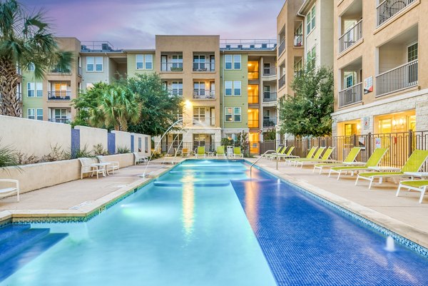 Resort-style pool with lounge chairs at Ventura Ridge Apartments, a luxury property managed by Greystar