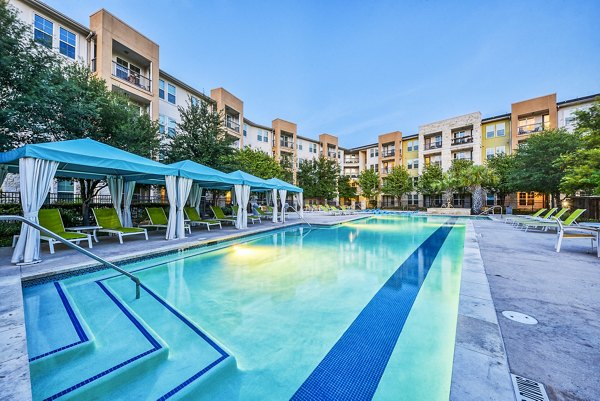 Luxurious swimming pool with lounge chairs at Ventura Ridge Apartments