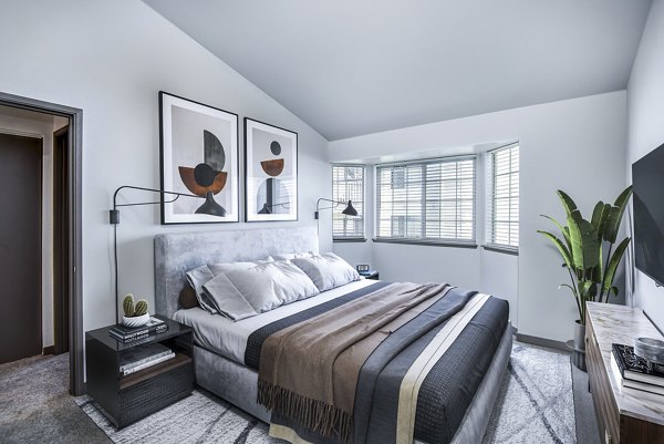 Cozy bedroom with modern furnishings at Capitol Heights Apartments, perfect for luxury living in the heart of the city