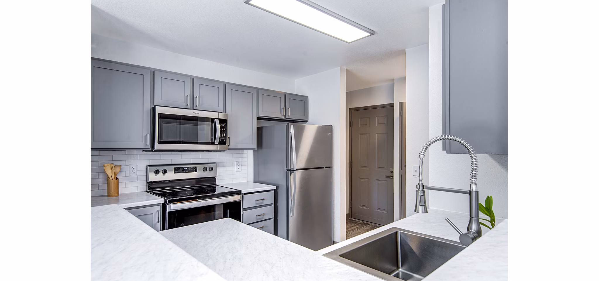 Modern kitchen with stainless steel appliances in Capitol Heights Apartments, offering luxury living experiences