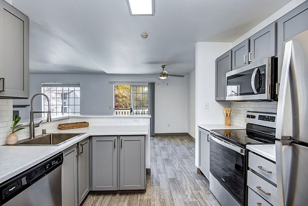 Contemporary kitchen with sleek countertops and modern appliances in Capitol Heights Apartments