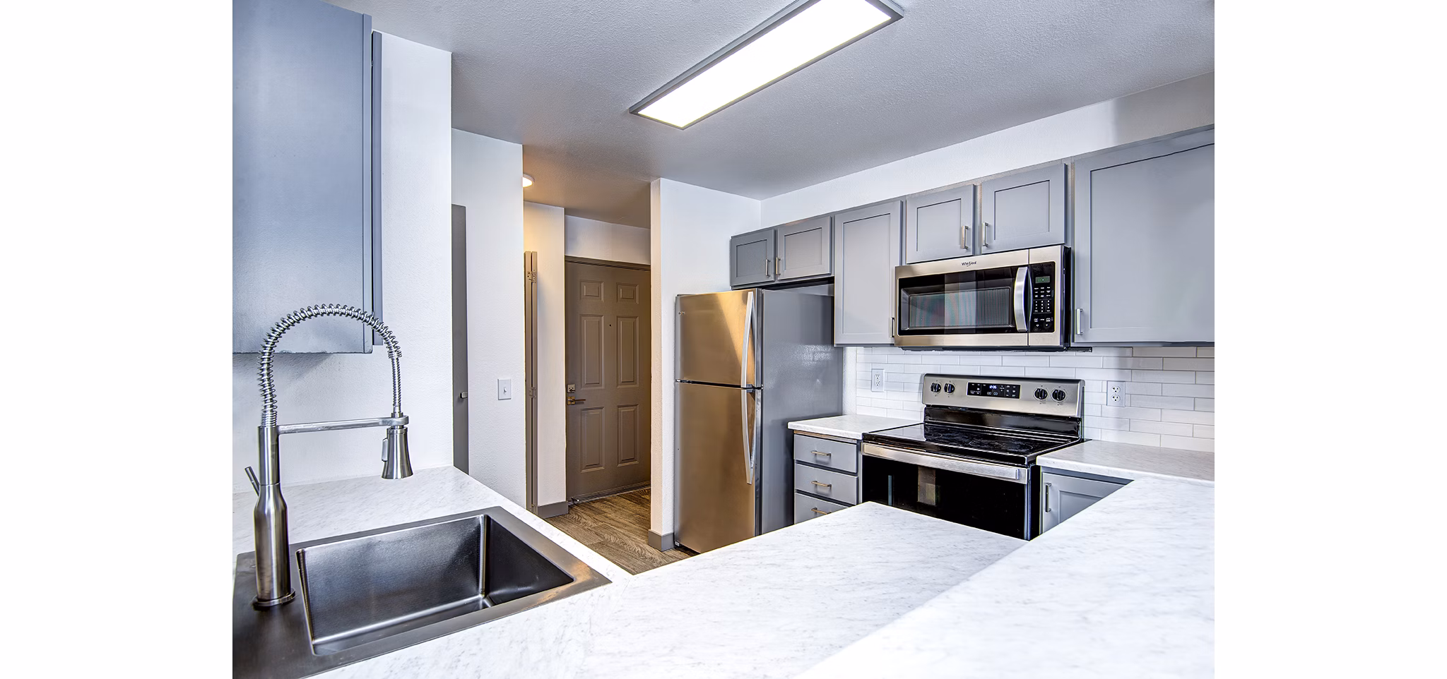 Modern kitchen with stainless steel appliances in Capitol Heights Apartments, luxury living in downtown Seattle