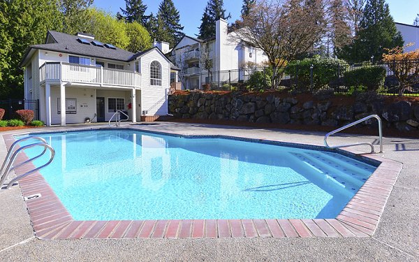 Outdoor swimming pool with lounge chairs at Capitol Heights Apartments