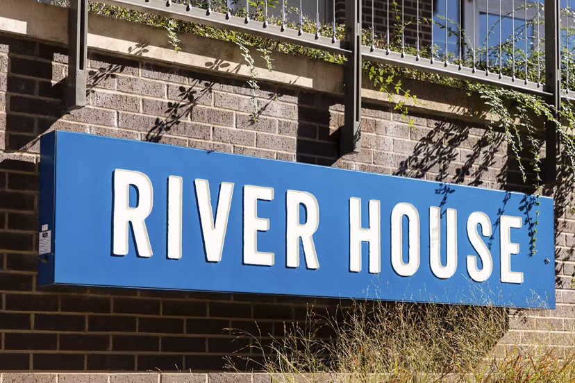 Outdoor signage at River House Apartments showcasing elegant branding