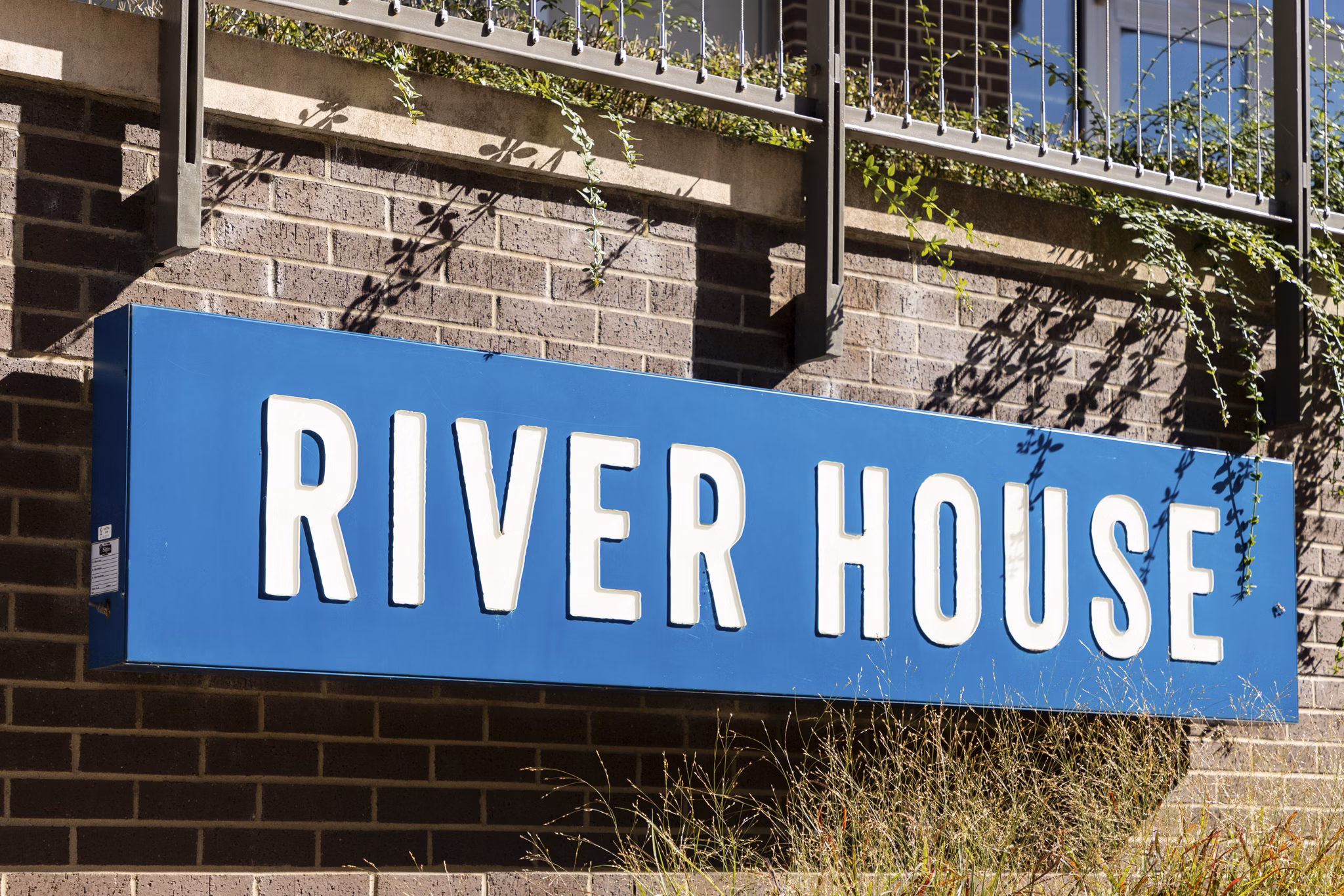 Outdoor signage at River House Apartments showcasing elegant branding