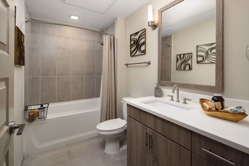 Bathroom at River House Apartments featuring sleek fixtures and modern design for a luxury living experience