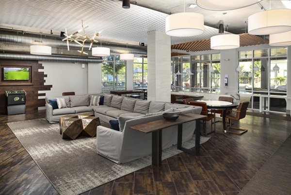 Modern clubhouse with cozy seating and fireplace at River House Apartments
