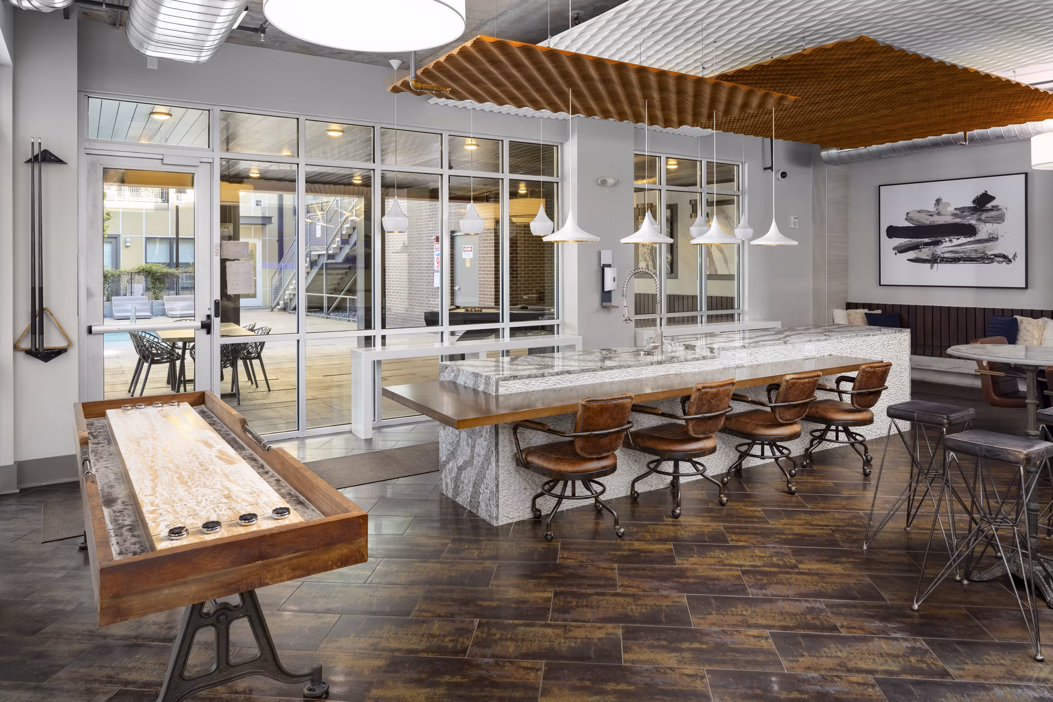 Modern game room with billiards and lounge seating at River House Apartments