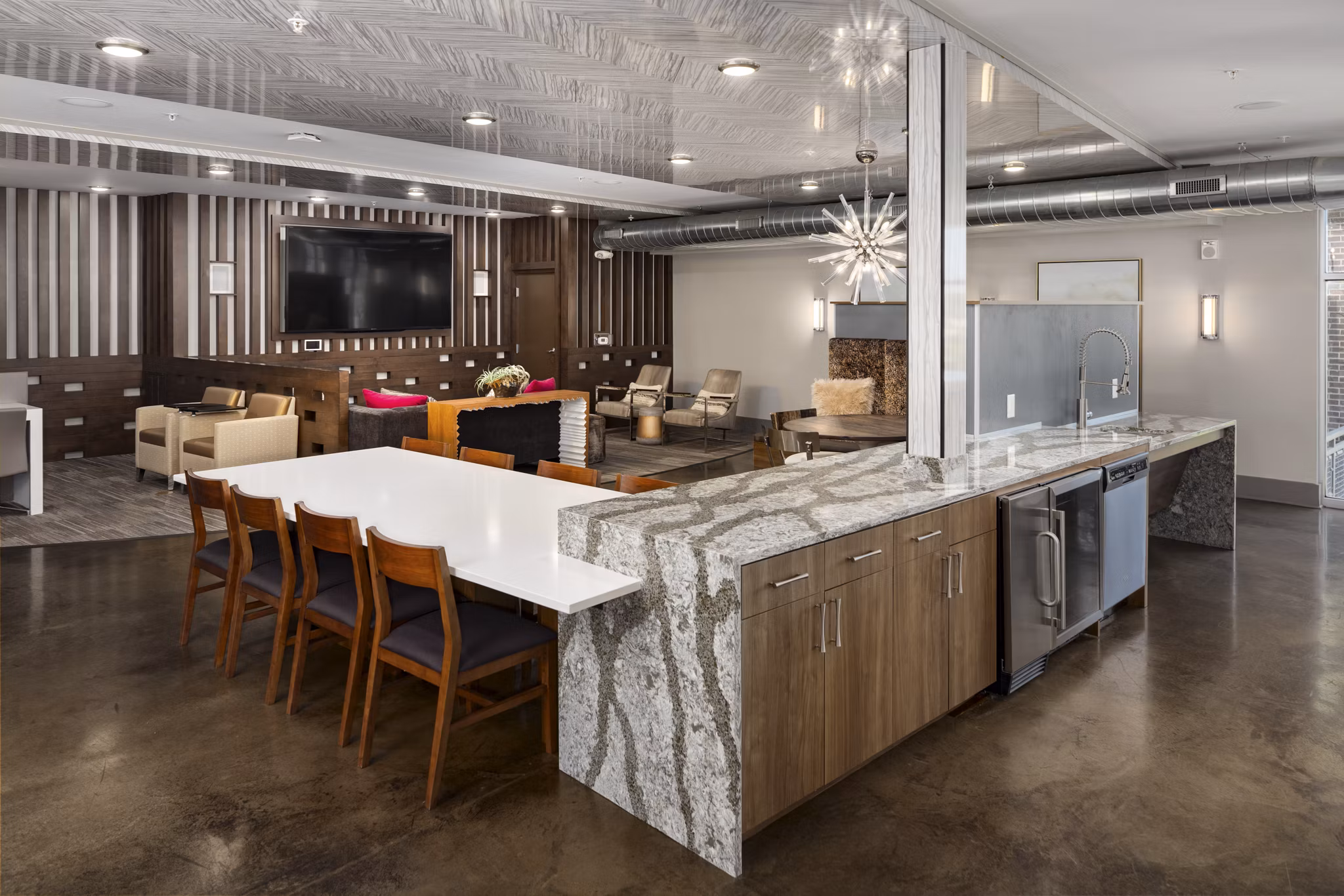 Clubhouse at River House Apartments: Modern design with plush seating and large windows for a luxurious social experience
