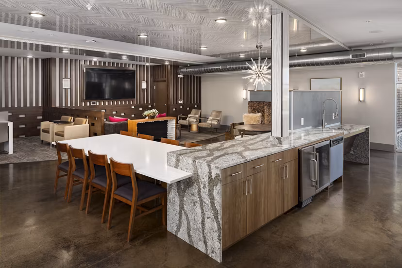 Clubhouse at River House Apartments: Modern design with plush seating and large windows for a luxurious social experience
