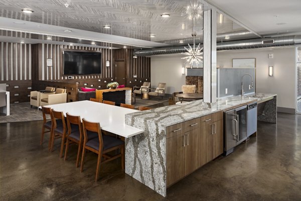 Clubhouse at River House Apartments: Modern design with plush seating and large windows for a luxurious social experience