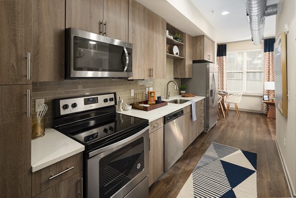 Modern kitchen with stainless steel appliances at River House Apartments