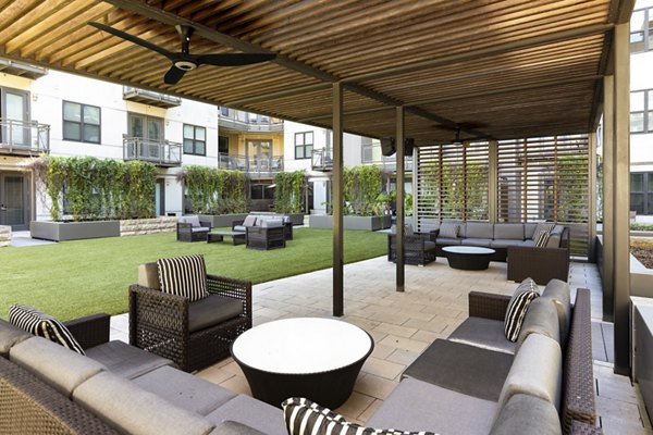 River House Apartments: Courtyard with lush landscaping and serene seating areas in a modern luxury setting