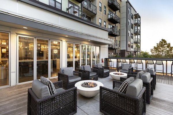 Cozy outdoor fire pit at River House Apartments, perfect for social gatherings and relaxation in a luxurious setting