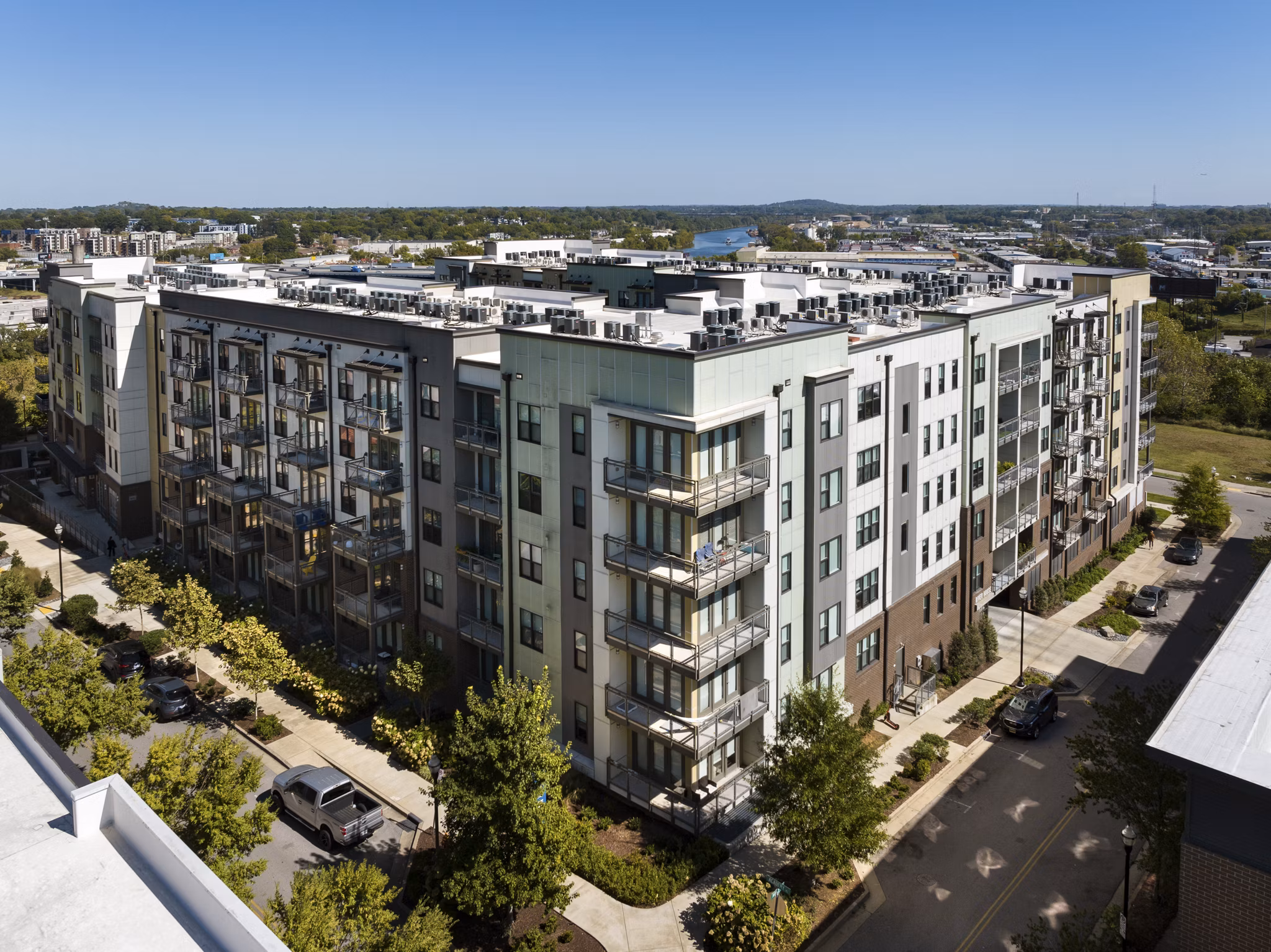 Luxury apartments featuring balconies and landscaped surroundings in a modern multi-story building
