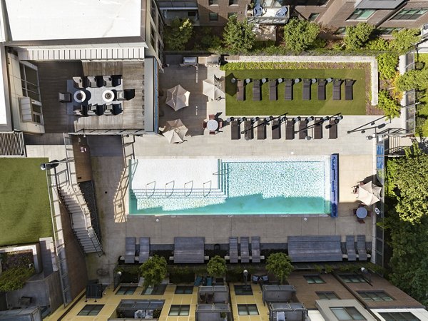 Aerial view of luxury apartments featuring a swimming pool and outdoor lounge areas