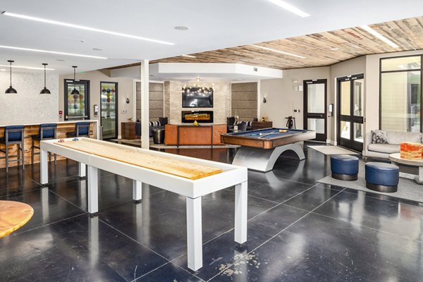 Clubhouse game room with billiards and lounge seating at Terra House Apartments