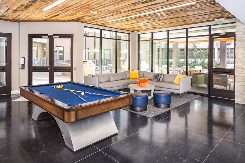 Clubhouse game room with billiards and seating at Terra House Apartments, perfect for social gatherings and entertainment