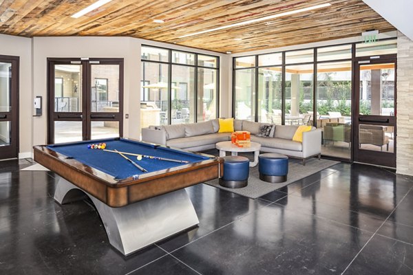 Clubhouse game room with billiards and seating at Terra House Apartments, perfect for social gatherings and entertainment