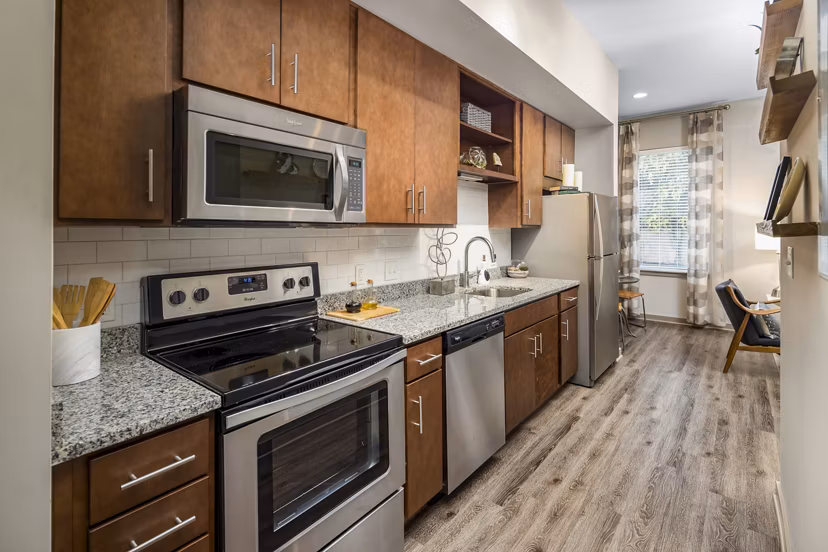 Modern kitchen with stainless steel appliances at Terra House Apartments, offering luxury living and contemporary design