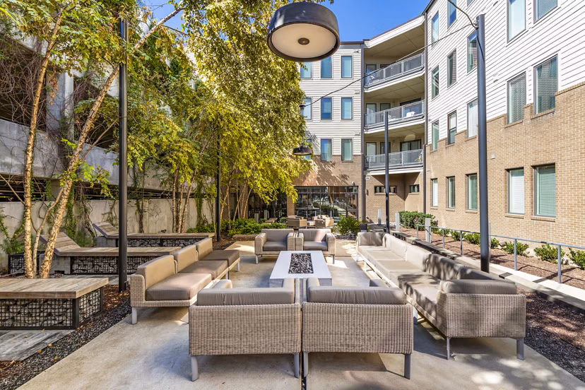 Fire pit and seating area on the patio at Terra House Apartments, offering luxurious outdoor relaxation spaces in the heart of the city