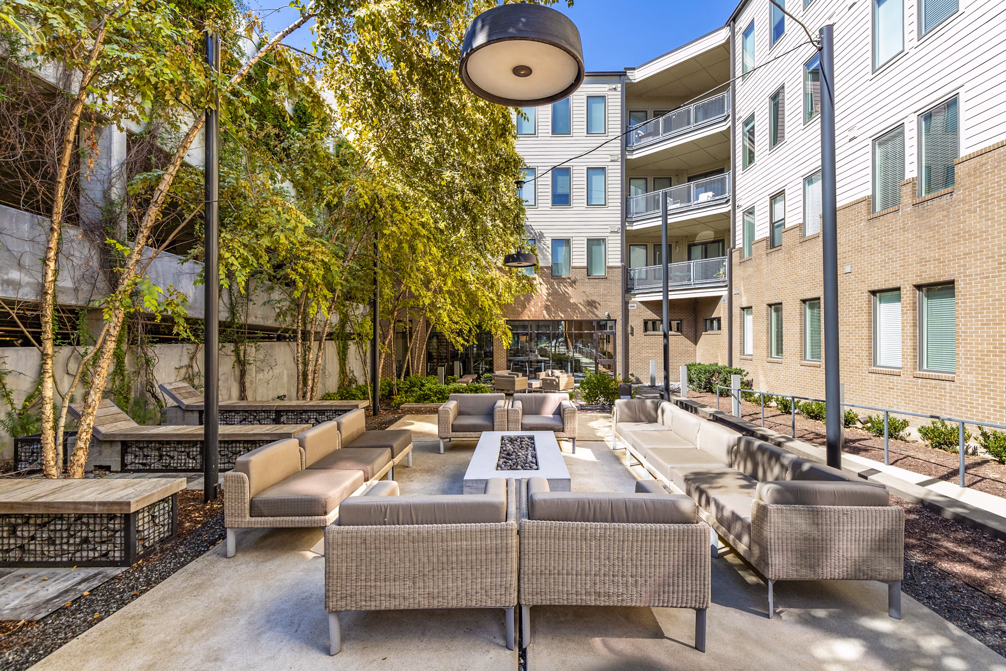 Fire pit and seating area on the patio at Terra House Apartments, offering luxurious outdoor relaxation spaces in the heart of the city