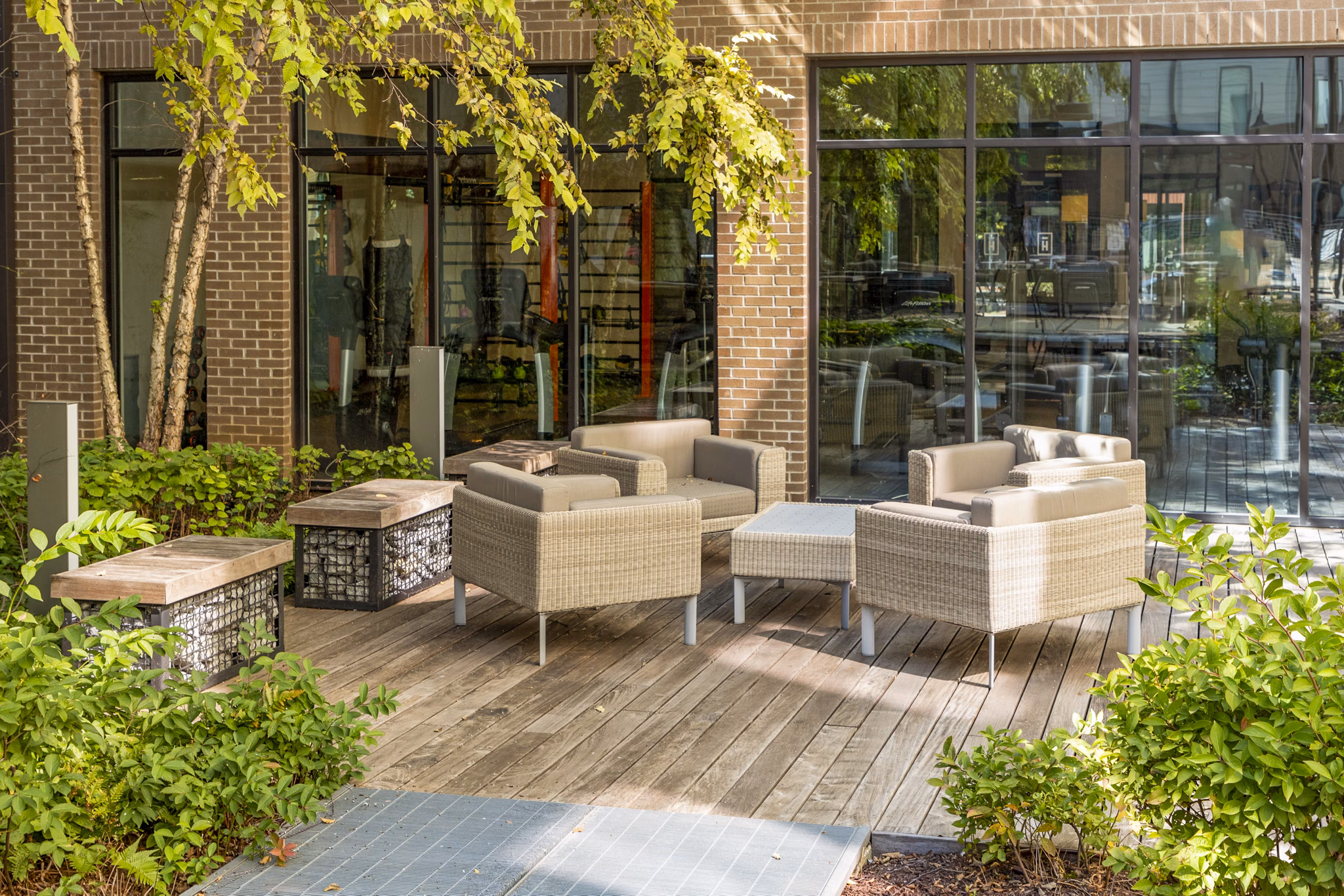 Patio with lounge seating and city views at Terra House Apartments