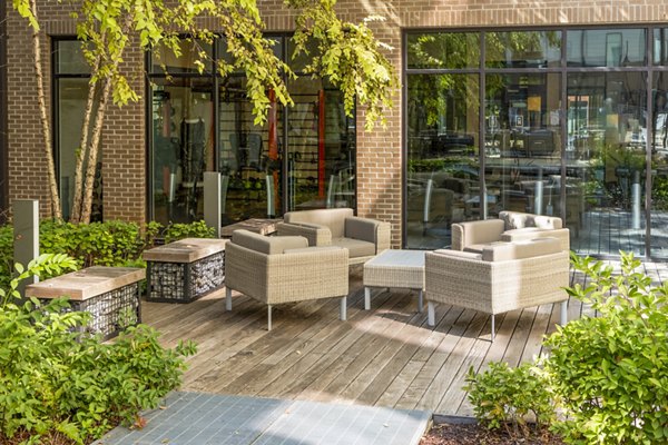 Patio with lounge seating and city views at Terra House Apartments