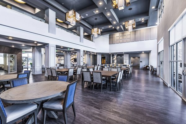 Clubhouse dining area with elegant seating and modern lighting at Larkspur at Creekside Apartments, offering a luxurious community experience