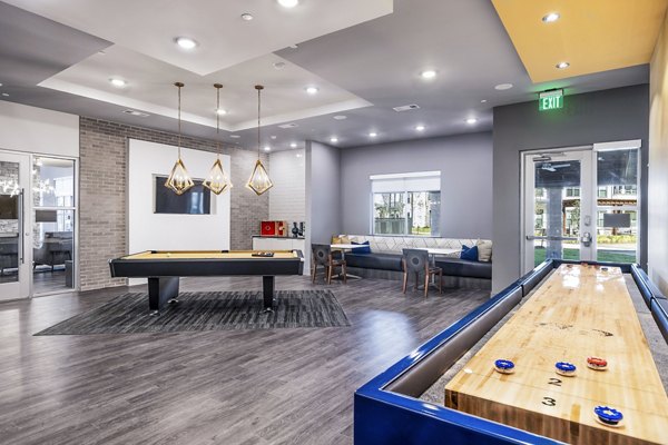 Clubhouse game room with pool table and seating area at Larkspur at Creekside Apartments, ideal for socializing and leisure activities