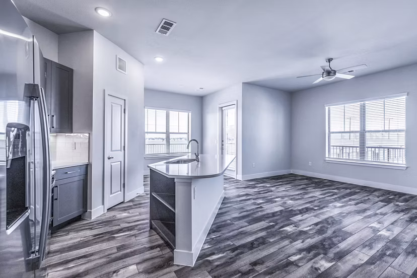 Larkspur at Creekside Apartments: Modern kitchen with stainless steel appliances and granite countertops