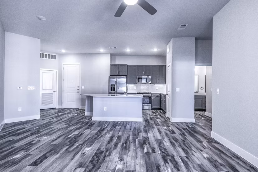 Open-concept dining and living room with modern decor at Larkspur at Creekside Apartments