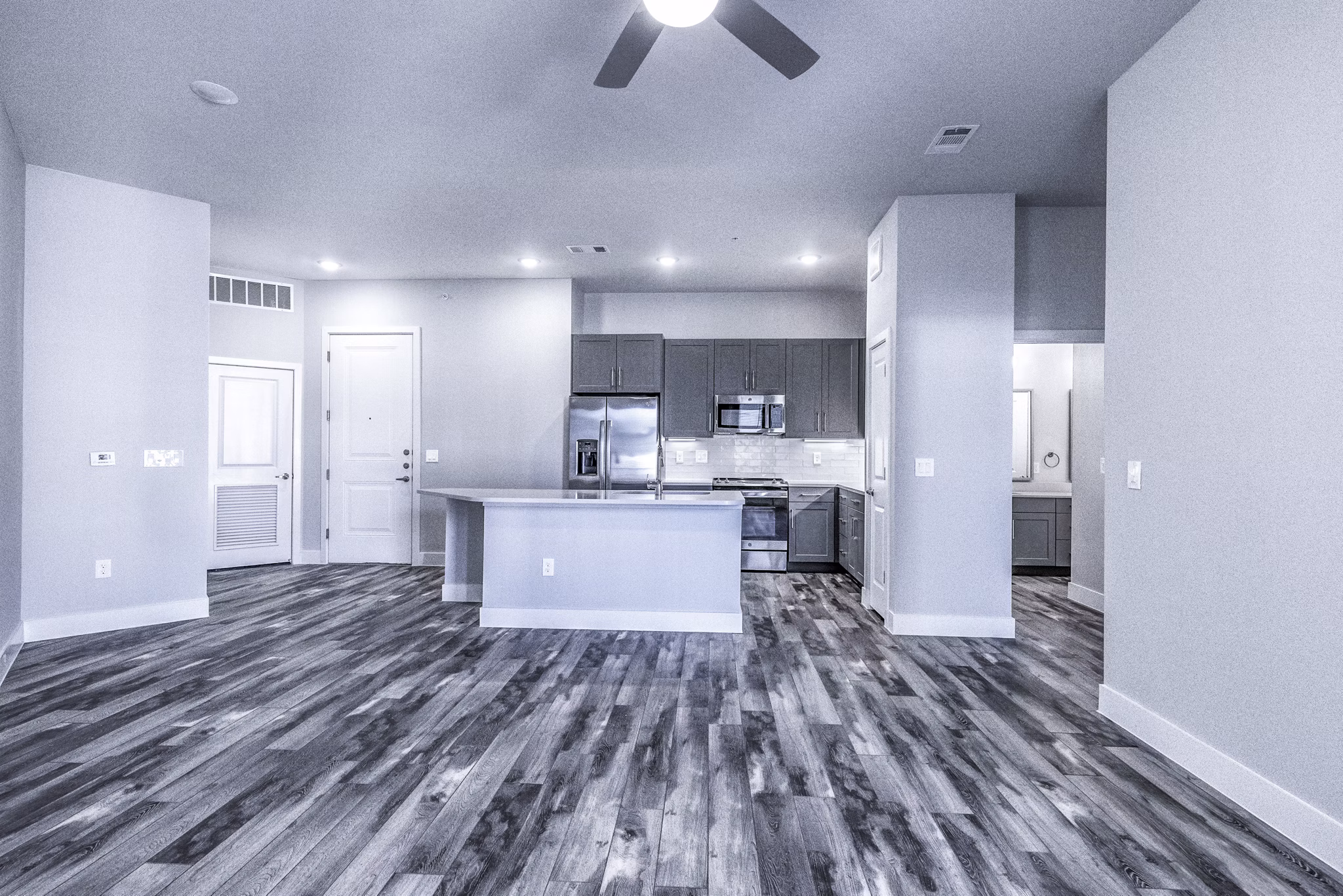 Open-concept dining and living room with modern decor at Larkspur at Creekside Apartments