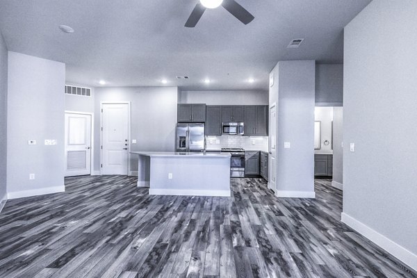 Open-concept dining and living room with modern decor at Larkspur at Creekside Apartments