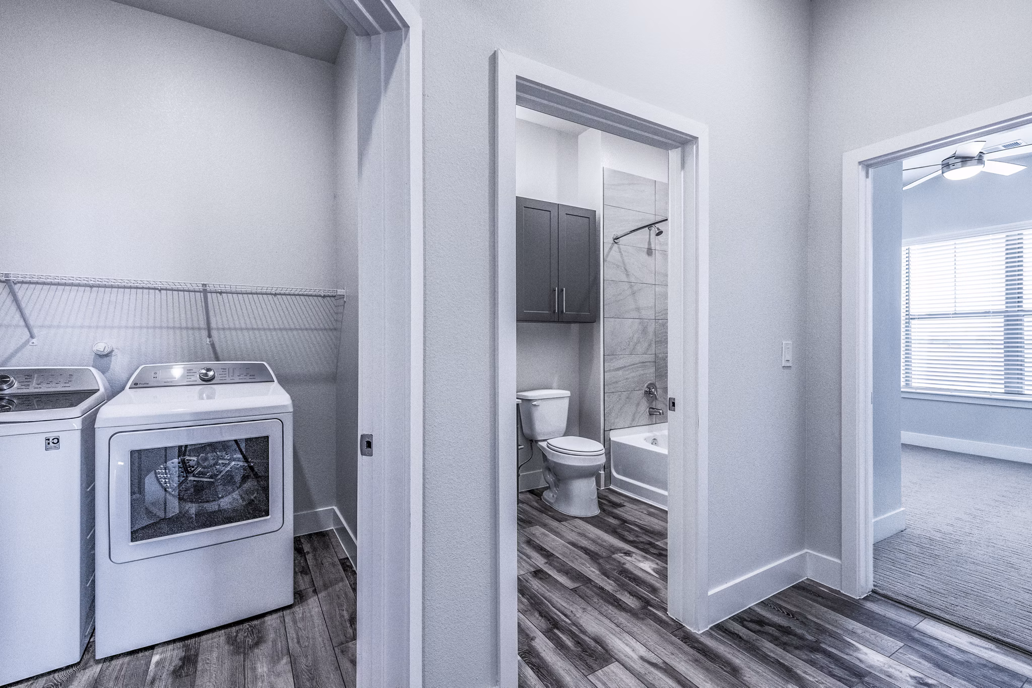 Laundry area and modern bathroom with sleek design at Larkspur at Creekside Apartments, featuring spacious countertops and in-unit washer and dryer