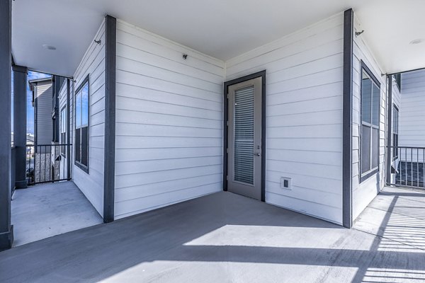 Private balcony with serene views at Larkspur at Creekside Apartments, ideal for relaxation and outdoor enjoyment