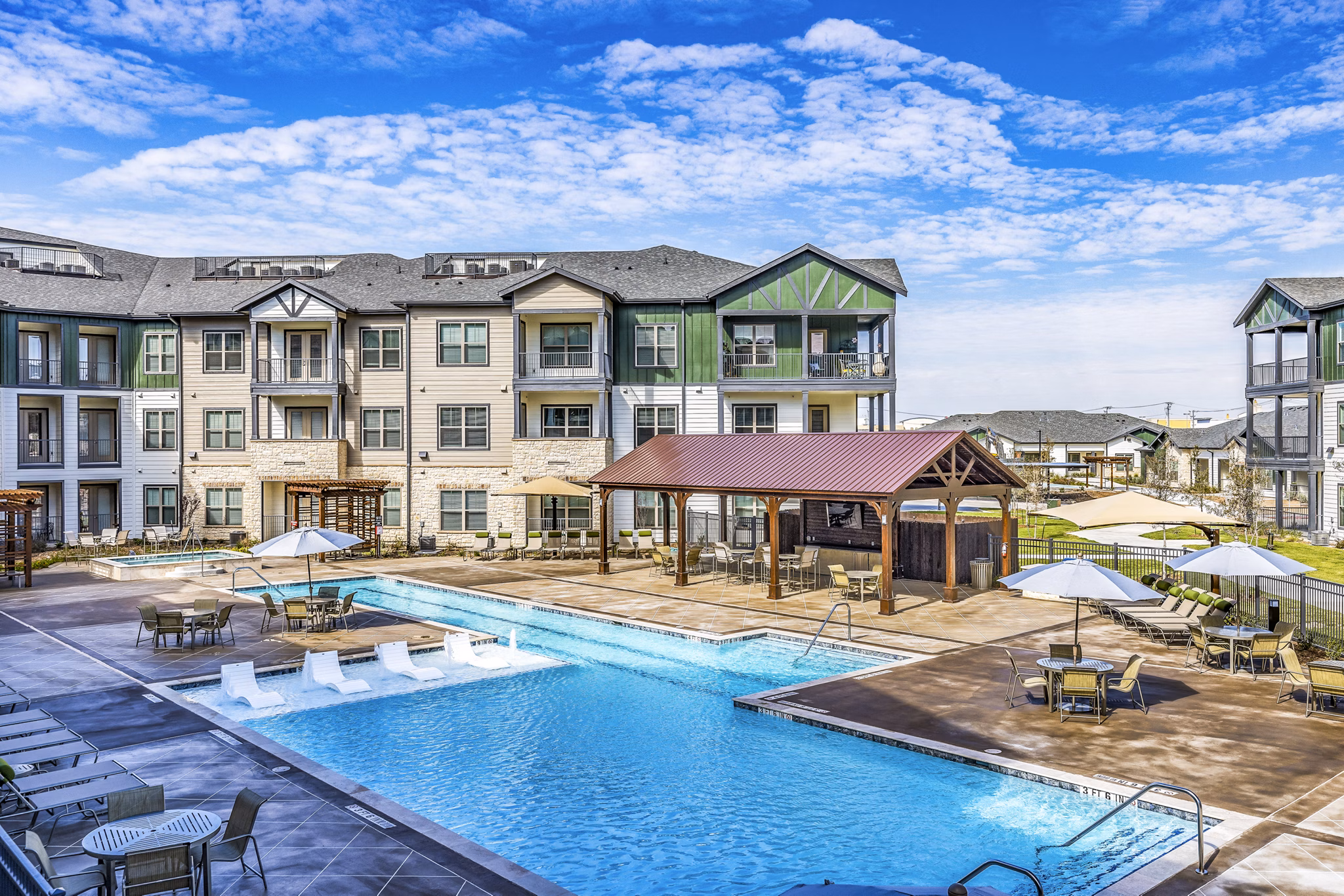 Resort-style pool at Larkspur at Creekside Apartments, offering luxury relaxation and stunning views