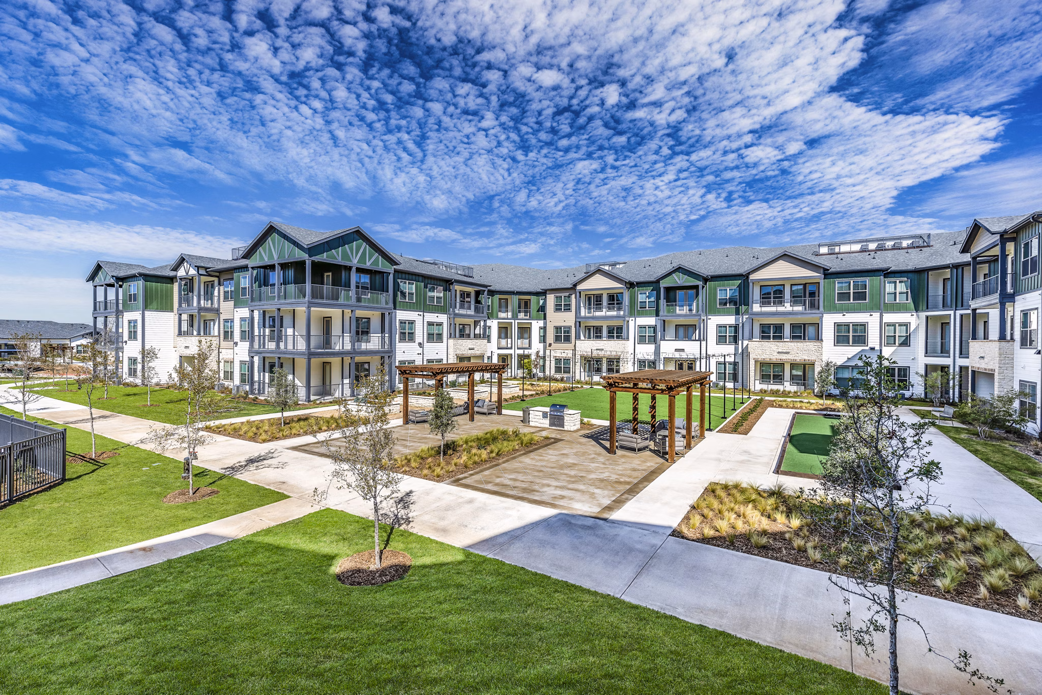 Modern courtyard grill area offering outdoor dining at Larkspur at Creekside Apartments