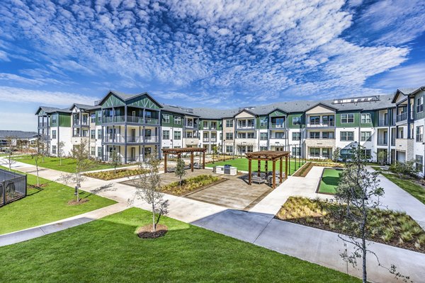 Modern courtyard grill area offering outdoor dining at Larkspur at Creekside Apartments