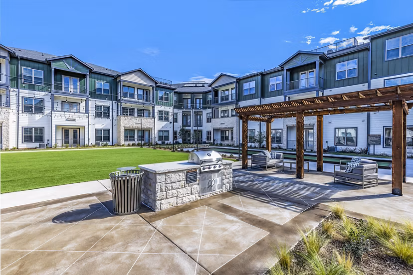 Grill area with modern barbecue stations at Larkspur at Creekside Apartments