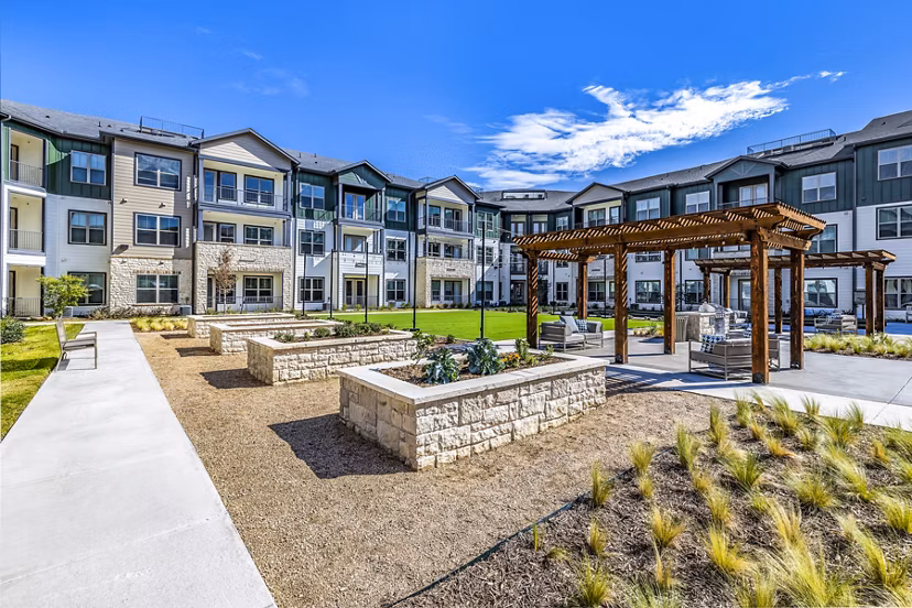 Outdoor courtyard with BBQ grill area at Larkspur at Creekside Apartments offering a perfect space for gatherings and relaxation