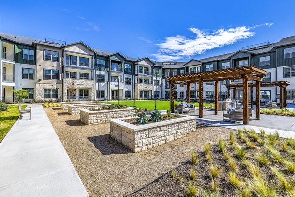 Outdoor courtyard with BBQ grill area at Larkspur at Creekside Apartments offering a perfect space for gatherings and relaxation