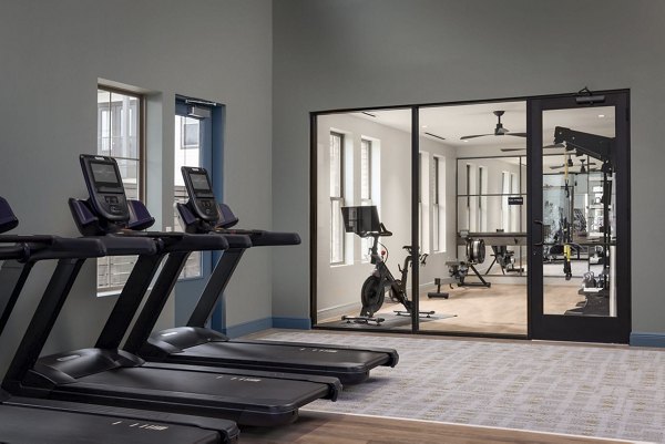 fitness center at The Louise Apartments